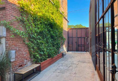 New York Inspired Outdoor Space with Red Brick Walls, Vines and String Lights